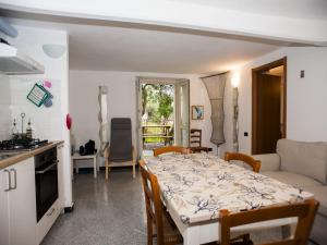 a kitchen and a living room with a table and chairs at Il Leudo in Levanto