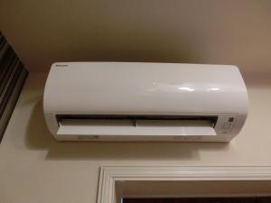 a white printer is hanging on a wall at Hotel Hyper Noah (Adult Only) in Sakai
