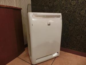a white refrigerator in a room with a wall at Hotel Hyper Noah (Adult Only) in Sakai
