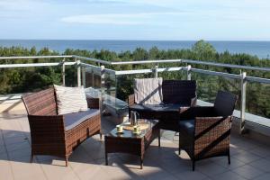 patio z krzesłami i stołem na balkonie w obiekcie Apartamenty Karin Wladyslawowo we Władysławowie