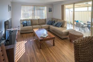 a living room with a couch and a table at Indoyo Retreat in Busselton