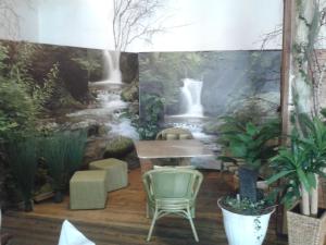a dining room with a waterfall mural on the wall at Landgasthof Schönecke in Wahrenholz