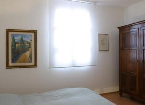 a bedroom with a bed and a picture on the wall at Il Borghetto in Cavriago