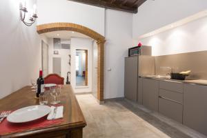 a kitchen with a wooden table and a counter top at Roman Forum Suite in Rome