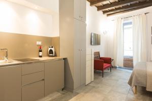 a kitchen with a sink and a bed in a room at Roman Forum Suite in Rome