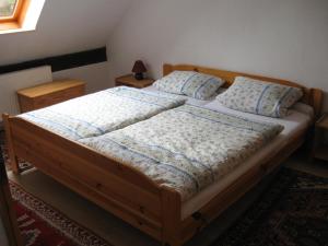 a bedroom with a wooden bed with two pillows at Ferienwohnung Rust in Warnitz