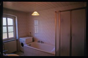 a bathroom with a tub and a toilet and a sink at Ferienwohnung Rust in Warnitz