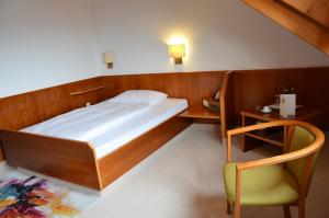 Postel nebo postele na pokoji v ubytování Hotel Garni Reulein