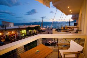 a balcony with a bench and a view of the ocean at G. Kiapekou in Loutra Edipsou