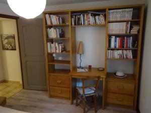 a room with a desk and book shelves at Havre de Paix in Vernet