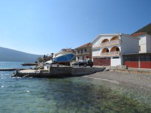 a boat is docked at a dock near the water at Stan Apatman Mirela in Herceg-Novi