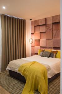 a bedroom with a large bed with a large headboard at Ocean Center Apartments in Cascais