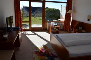 Postel nebo postele na pokoji v ubytování Hotel Garni Reulein