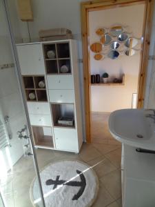 a bathroom with a sink and a glass shower at Land & Meer in Hasselberg