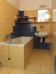 a bathroom with a tub and a sink at Garden 35 in Ivachnová +28 photos