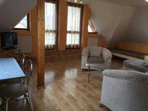 a living room with two chairs and a table at Garden 35 in Ivachnová