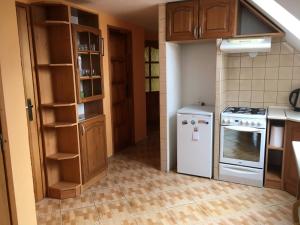 a kitchen with a stove and a refrigerator at Garden 35 in Ivachnová