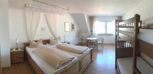 a bedroom with two beds and a bunk bed at Hotel Feiden Garni in Ediger-Eller
