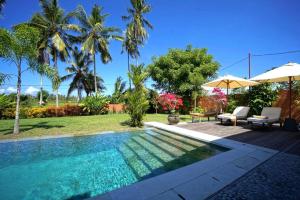 a swimming pool in the backyard of a villa at Villa Taman Kanti in Ubud