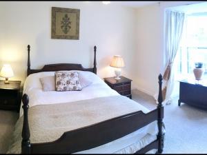 a bedroom with a bed and two lamps and a window at Rye High Street in Rye