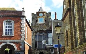 a building with a clock tower on top of it at Rye High Street in Rye