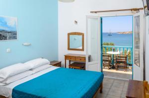 a bedroom with a bed and a view of the ocean at Hotel Livadia in Parikia