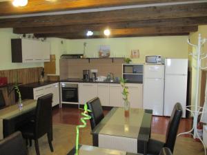 a kitchen and dining room with a table and refrigerator at Casa Soare check-in independent in Sighişoara