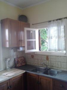 a kitchen with a sink and a window at Nicolas Dream in Nea Makri