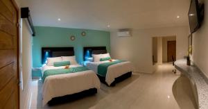Ένα ή περισσότερα κρεβάτια σε δωμάτιο στο Hotel Mumai