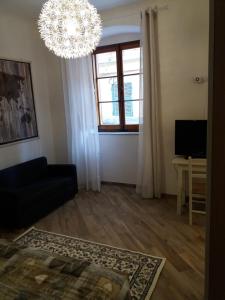 a living room with a black couch and a chandelier at Casa Silve in La Spezia