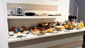a shelf with a bunch of food on it at Hotel Bella Júlia in Joinville