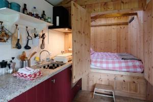 a kitchen with a bunk bed in a room with a sink at Vakantiehuisje met bedstee in Diever