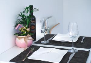 a table with a bottle of wine and two glasses at Ferienwohnung Jolene in Weil am Rhein