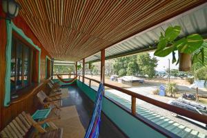 a balcony with a hammock on a house at Cafe de la Suerte in Pavones