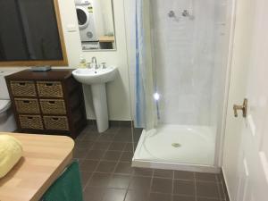 a bathroom with a sink and a shower and a toilet at Jarrah Glen Cabins in Nannup