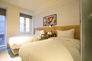 Postel nebo postele na pokoji v ubytování Re-Change Hotel Taipei