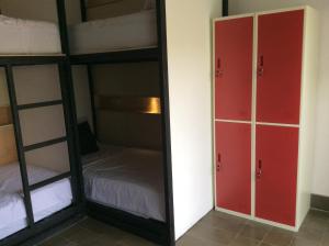 a room with two bunk beds and a mirror at The Patio Yogya in Yogyakarta