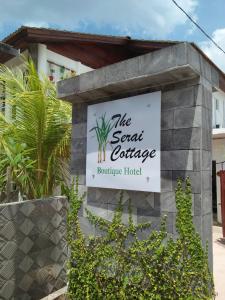 a sign for the secret cottage boutique hotel at The Serai Cottage Boutique Hotel in Kuala Berang
