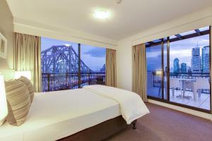 a hotel room with a large window overlooking the ocean at Oakwood Hotel & Apartments Brisbane in Brisbane