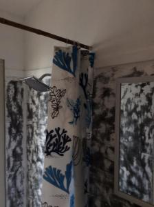 a blue and white curtain in a room with a lamp at The Patio Yogya in Yogyakarta