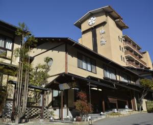 un edificio con una torre de reloj encima en Hotel Umenoyu, en Matsumoto