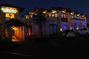 ein Gebäude mit einem Auto, das nachts davor geparkt ist in der Unterkunft Anta Boga Hotel in Bloemfontein