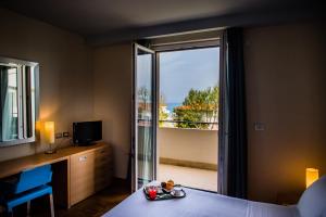 a hotel room with a bed and a tv at Phi Hotel Alcione in Francavilla al Mare
