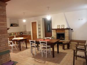 a kitchen and dining room with a table and a fireplace at Agriturismo Fonte Carra in Grottazzolina +29 photos