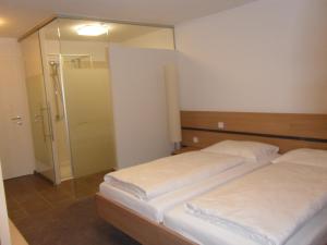 A bed or beds in a room at Gasthof-Pension Schütz