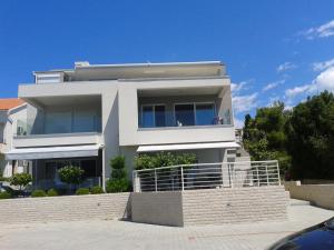 a large white house with a lot of windows at Apartments Lana in Novalja