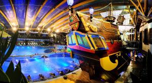 a large indoor water park with a large pool at Tatralandia Romantická Záhrada Chata 345 in Vyšné Malatíny