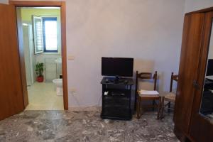 a living room with a television on a table at La Scogliera B&B in San Vito Chietino