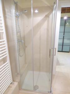 a shower with a glass door in a bathroom at Ca' Neldo - VeniseJeTAime in Venice