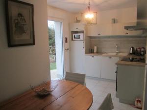 a kitchen with a wooden table in a room at Fairbanks in Hardecourt-aux-Bois